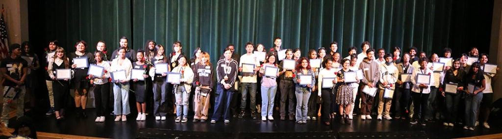 A large group of students gather for a photo in the Franklin auditorium